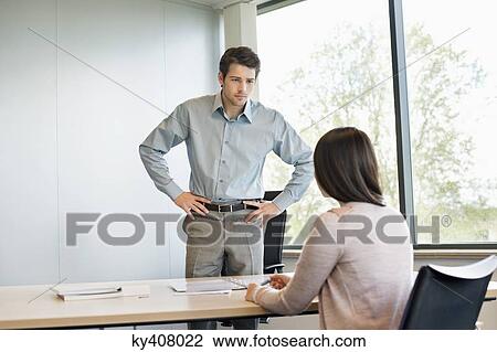 Stock Image - Business executive discussing with his client. Fotosearch