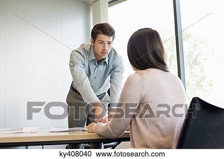 Business executive discussing with his client View Large Photo Image Stock Image - Business executive discussing with his client. Fotosearch