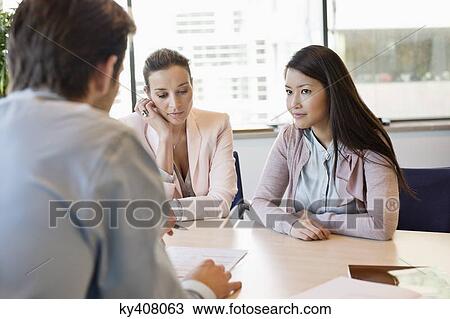 Stock Image - Business executive discussing with his clients. Fotosearch