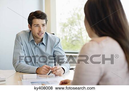 Business executive discussing with his client View Large Photo Image Stock Photo - Business executive discussing with his client. Fotosearch