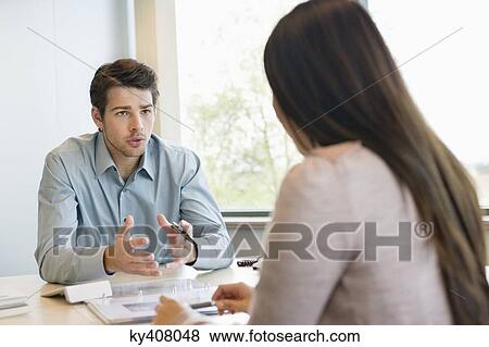 Business executive discussing with his client View Large Photo Image Stock Photo - Business executive discussing with his client. Fotosearch