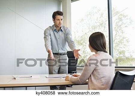 Business executive discussing with his client View Large Photo Image Stock Photo - Business executive discussing with his client. Fotosearch