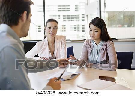 Stock Photo - Business executive giving business card to his clients. Fotosearch