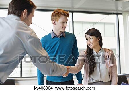 Picture - Business executive shaking hands with his clients. Fotosearch