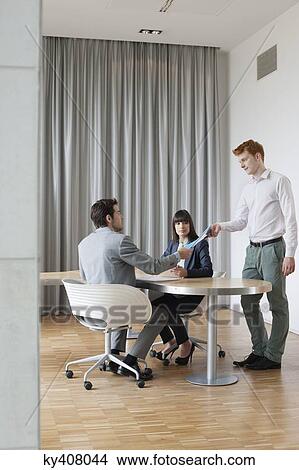 Picture - Business executives having a meeting in an office. Fotosearch