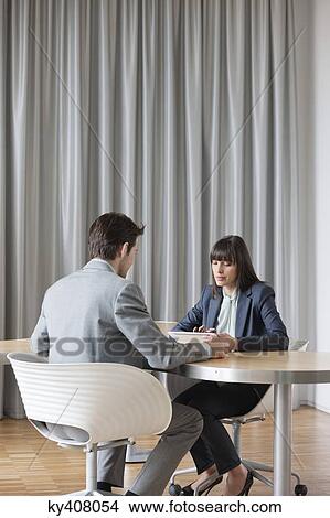 Picture - Business executives having a meeting in an office. Fotosearch