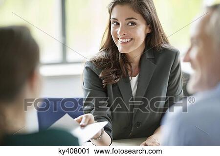 Business executives having a meeting in an office View Large Photo Image Stock Image - Business executives having a meeting in an office. Fotosearch