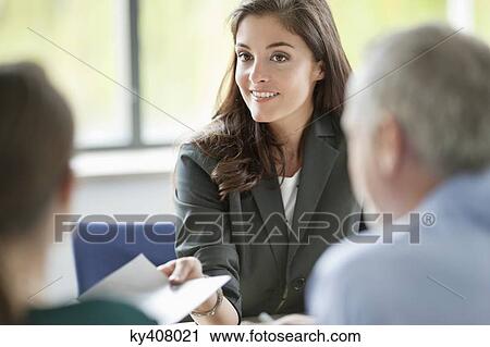 Business executives having a meeting in an office View Large Photo Image Stock Image - Business executives having a meeting in an office. Fotosearch