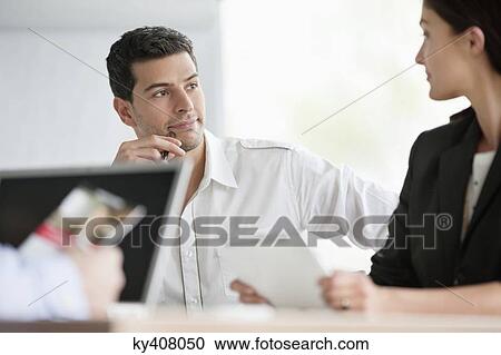Business executives having a meeting in an office View Large Photo Image Stock Image - Business executives having a meeting in an office. Fotosearch