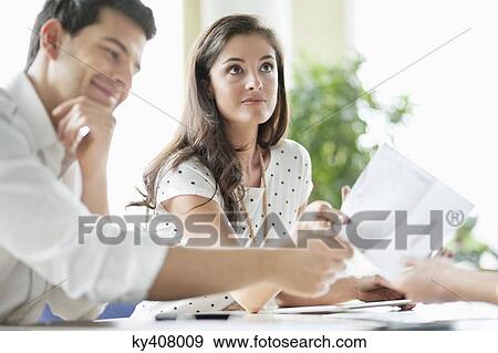 Stock Photo - Business executives having a meeting in an office. Fotosearch