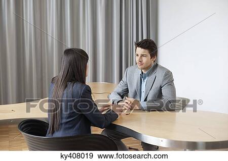 Business executives having a meeting in an office View Large Photo Image Stock Photo - Business executives having a meeting in an office. Fotosearch
