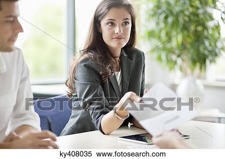 Business executives having a meeting in an office View Large Photo Image Stock Photography - Business executives having a meeting in an office. Fotosearch