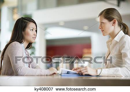 Businesswomen working in an office View Large Photo Image Stock Photo - Businesswomen working in an office. Fotosearch