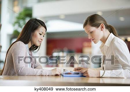 Stock Photo - Businesswomen working in an office. Fotosearch