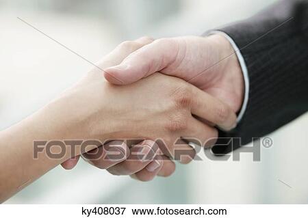 Close-up of business executives shaking hands in an office View Large Photo Image Stock Photo - Close-up of business executives shaking hands in an office. Fotosearch