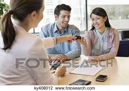 Couple receiving keys from business executive View Large Photo Image Stock Image - Couple receiving keys from business executive. Fotosearch