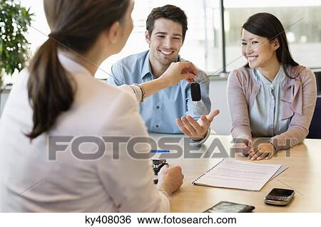 Couple receiving keys from business executive View Large Photo Image Stock Photograph - Couple receiving keys from business executive. Fotosearch
