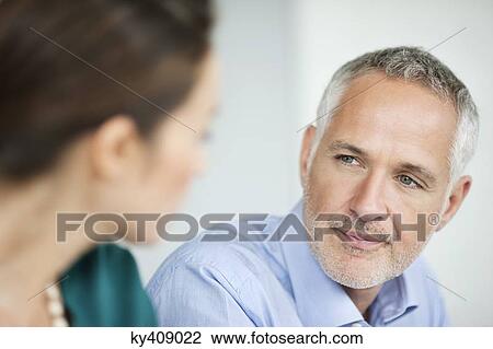 Business executives discussing in an office View Large Photo Image Stock Image - Business executives discussing in an office. Fotosearch