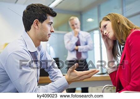 Stock Image - Business executives discussing in an office. Fotosearch