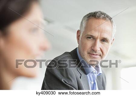 Business executives discussing in an office View Large Photo Image Stock Image - Business executives discussing in an office. Fotosearch