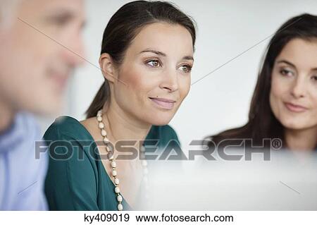 Business executives having a meeting in an office View Large Photo Image Stock Photo - Business executives having a meeting in an office. Fotosearch