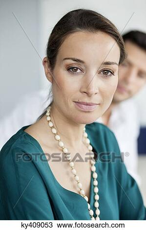 Stock Image - Portrait of a businesswoman in an office. Fotosearch