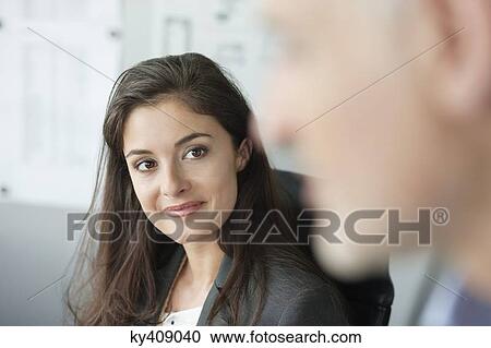 Stock Image - Portrait of a businesswoman smiling. Fotosearch