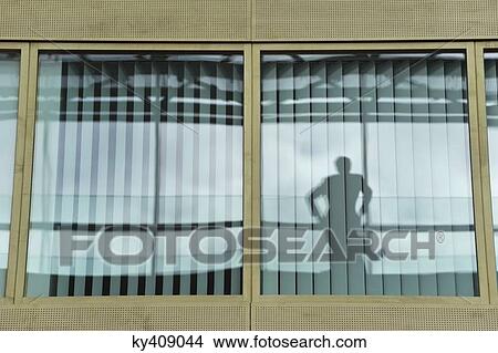 Reflection of a person on the glass of an office window View Large Photo Image Picture - Reflection of a person on the glass of an office window. Fotosearch