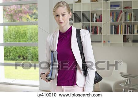 Stock Image - Businesswoman leaving for office. Fotosearch