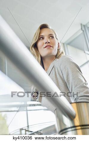 Businesswoman near staircase View Large Photo Image Stock Photograph - Businesswoman near staircase. Fotosearch