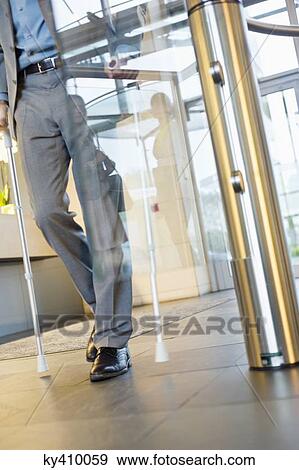 Disabled businessman entering the office View Large Photo Image Stock Photo - Disabled businessman entering the office. Fotosearch