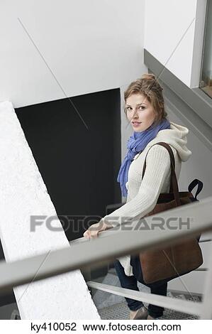 Portrait of a woman moving down stairs View Large Photo Image Stock Image - Portrait of a woman moving down stairs. Fotosearch