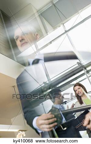 Reflection of business executives on window glass View Large Photo Image Stock Photo - Reflection of business executives on window glass. Fotosearch