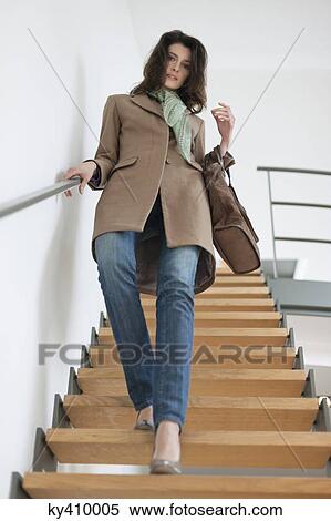 Woman moving down stairs View Large Photo Image Stock Photography - Woman moving down stairs. Fotosearch