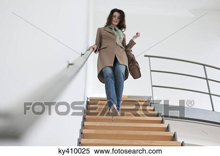 Woman moving down stairs View Large Photo Image Stock Photography - Woman moving down stairs. Fotosearch
