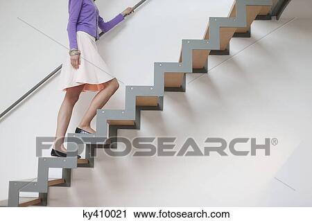 Woman moving up stairs View Large Photo Image Stock Image - Woman moving up stairs. Fotosearch