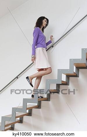 Woman moving up stairs View Large Photo Image Stock Image - Woman moving up stairs. Fotosearch