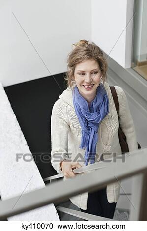Woman moving up stairs View Large Photo Image Stock Image - Woman moving up stairs. Fotosearch