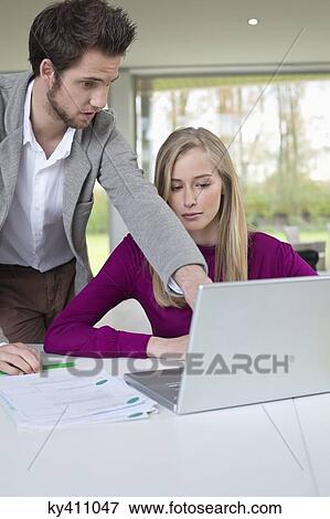 Couple working in home office View Large Photo Image Stock Photo - Couple working in home office. Fotosearch