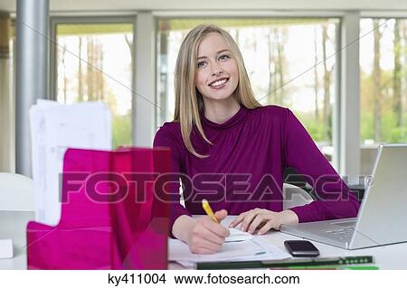 Happy businesswoman working in home office View Large Photo Image Picture - Happy businesswoman working in home office. Fotosearch