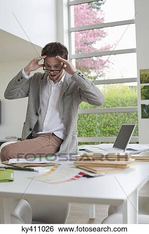 Interior designer looking surprised in the office View Large Photo Image Stock Photograph - Interior designer looking surprised in the office. Fotosearch