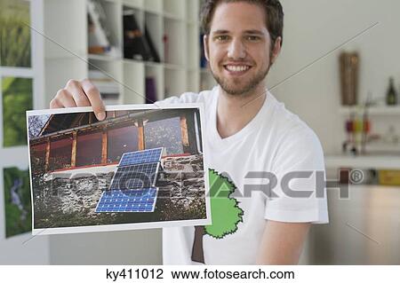 Man showing an ecological poster of solar panel View Large Photo Image Stock Image - Man showing an ecological poster of solar panel. Fotosearch