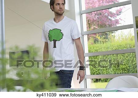 Man standing in a room View Large Photo Image Stock Photo - Man standing in a room. Fotosearch