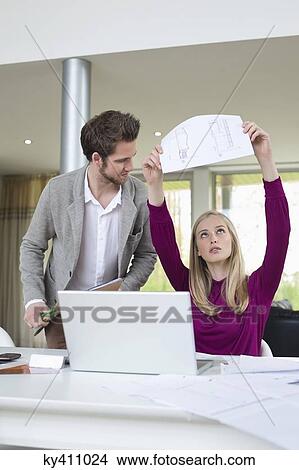 Woman examining an architectural design in the office View Large Photo Image Picture - Woman examining an architectural design in the office. Fotosearch