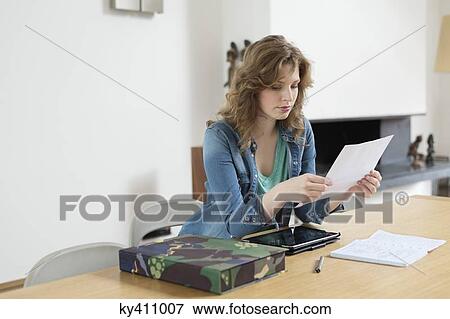 Woman sorting out bills View Large Photo Image Stock Photo - Woman sorting out bills. Fotosearch