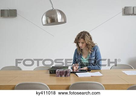 Woman sorting out bills View Large Photo Image Stock Photo - Woman sorting out bills. Fotosearch