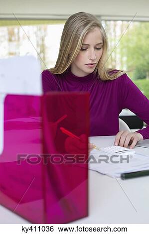 Stock Photograph - Woman working in home office. Fotosearch