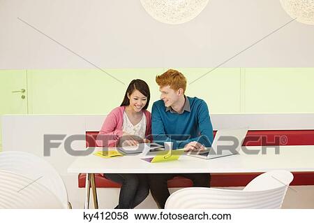 Business couple working in an office View Large Photo Image Stock Photo - Business couple working in an office. Fotosearch
