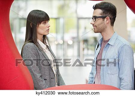 Business executives discussing in an office lobby View Large Photo Image Stock Image - Business executives discussing in an office lobby. Fotosearch