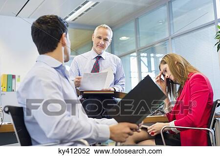 Business executives discussing in an office View Large Photo Image Stock Image - Business executives discussing in an office. Fotosearch